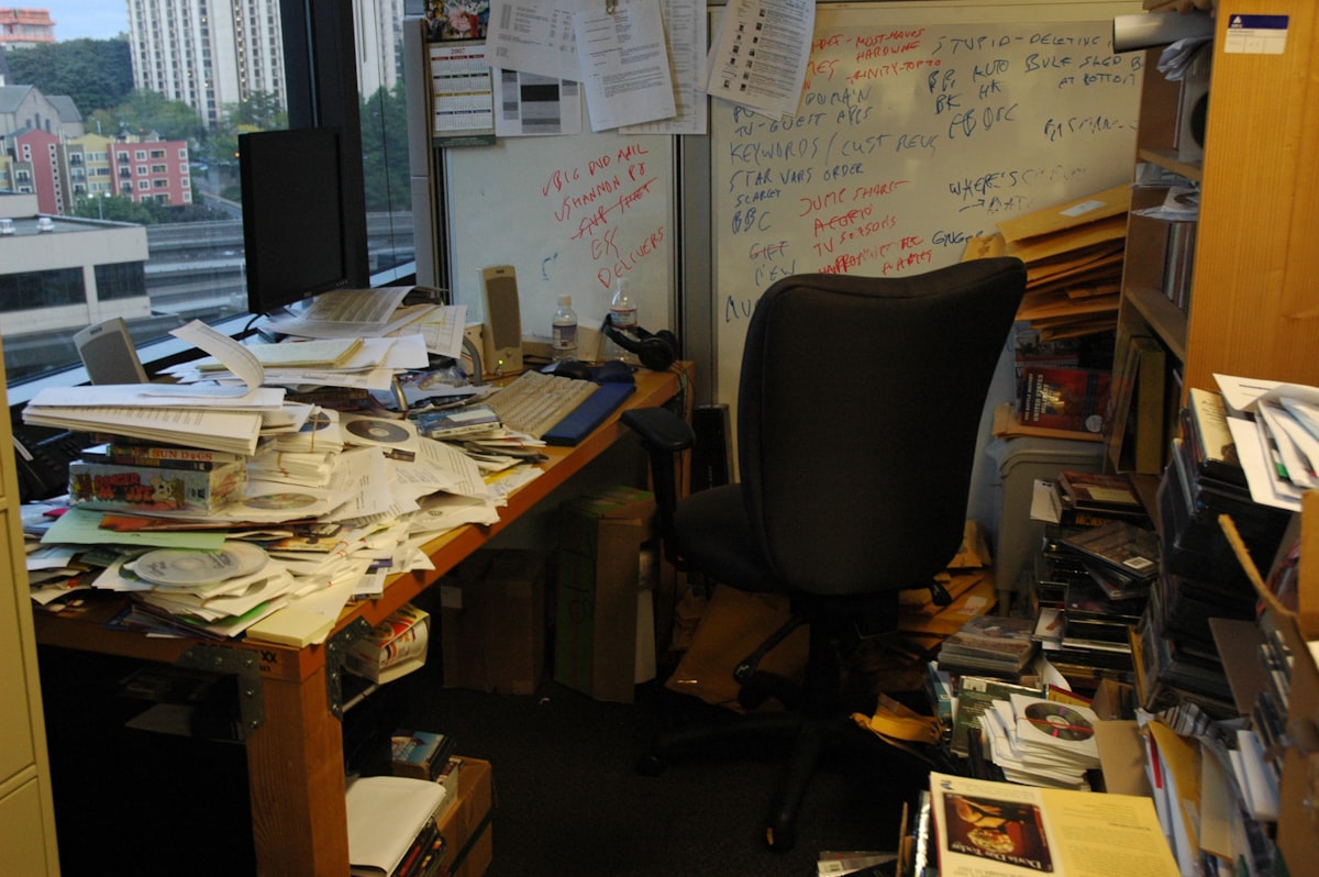 Office desk with piles of papers
